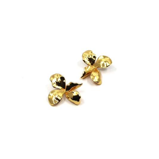 Pair of gold flower-shaped earrings on a white background