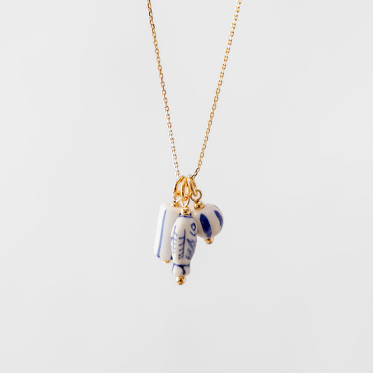 Necklace with a ceramic nautical pendant on a white background