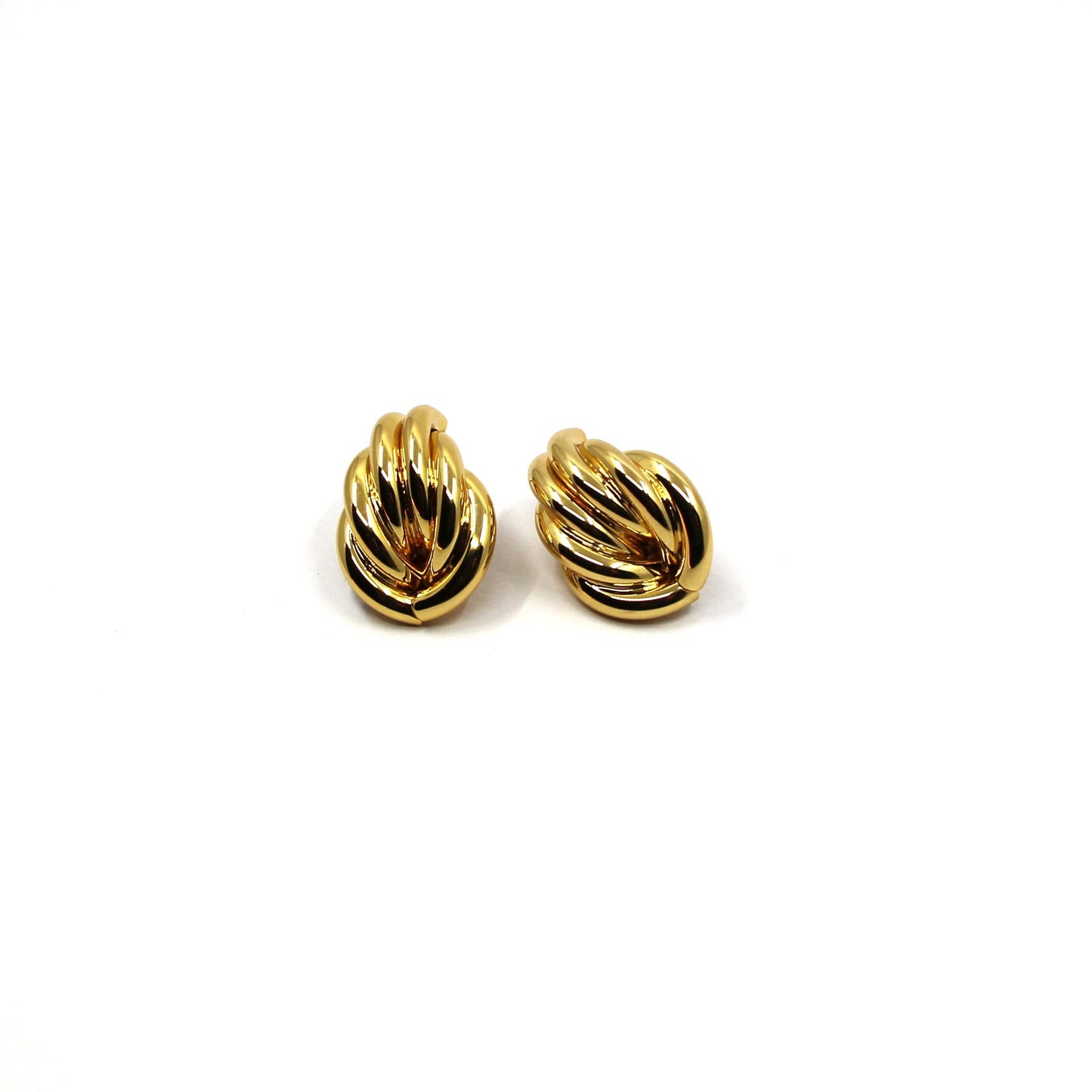 gold double knot statement earrings on a white background